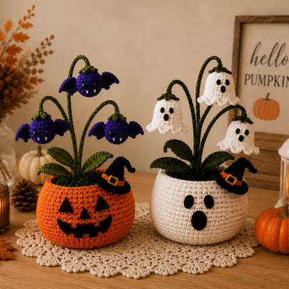 Two handmade crochet Halloween flower pots side by side, an orange jack-o'-lantern and a white ghost planter