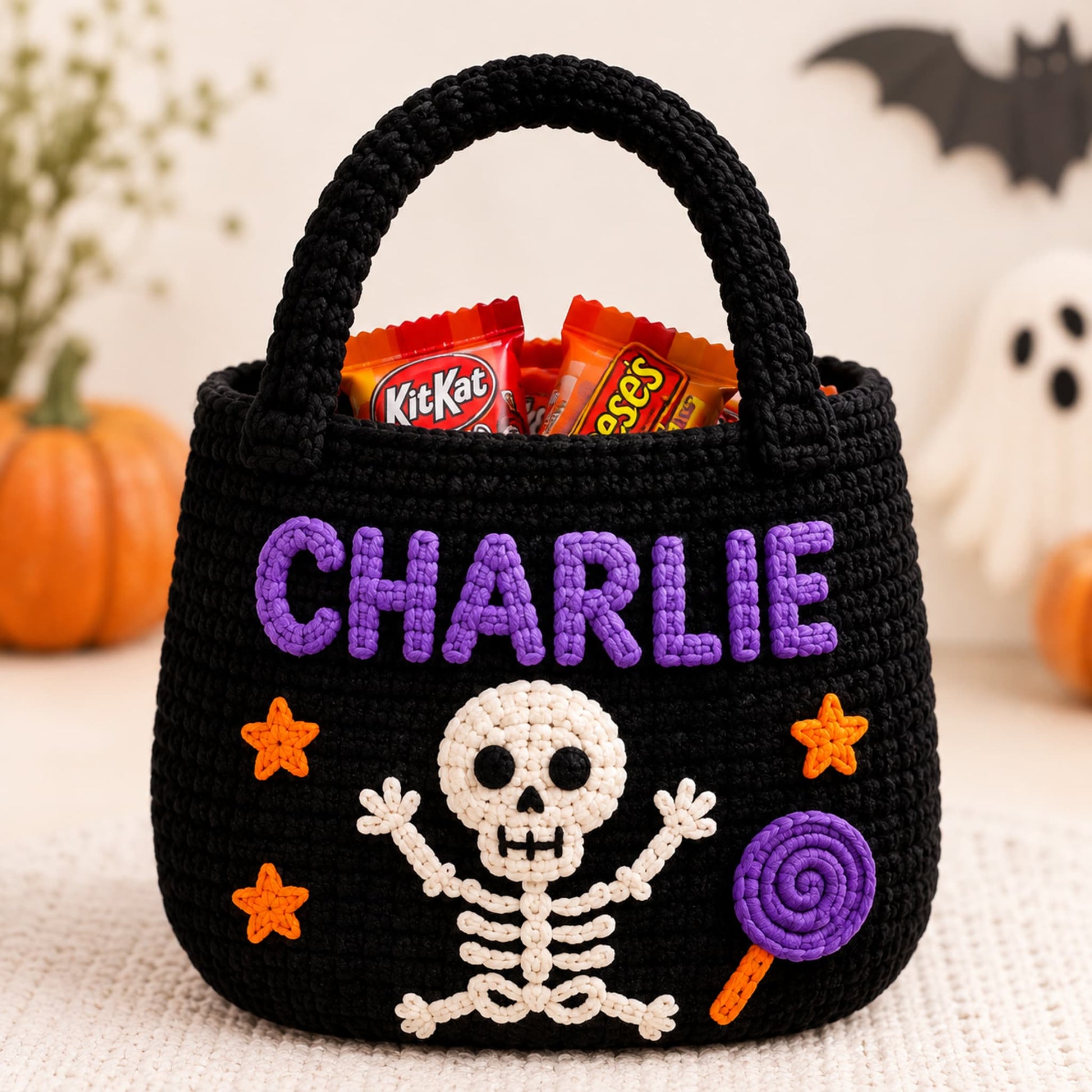 Black crochet trick or treat bag with a white skeleton, purple name letters and orange stars