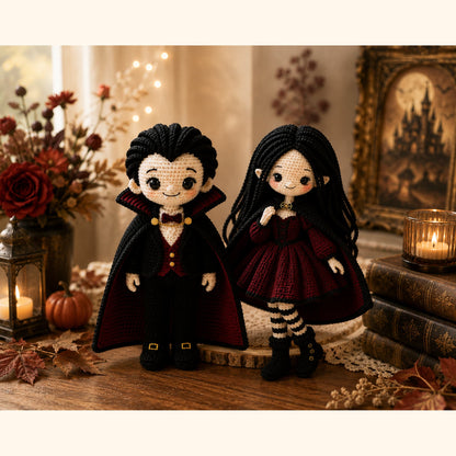 Handmade crochet Dracula and vampire girl dolls standing together on a wooden table by candlelight
